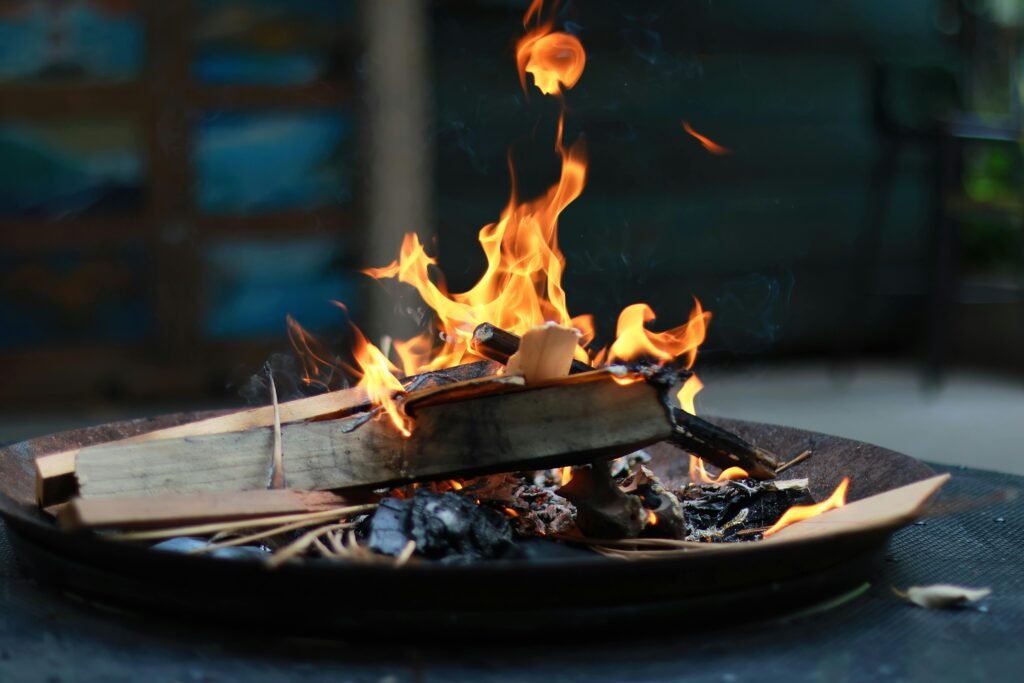 Close-up of a campfire with flames and wood logs, perfect for outdoor ambiance.
