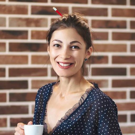happy woman sitting on the desk with a cup of coff uq5cx9l compressed square.jpg